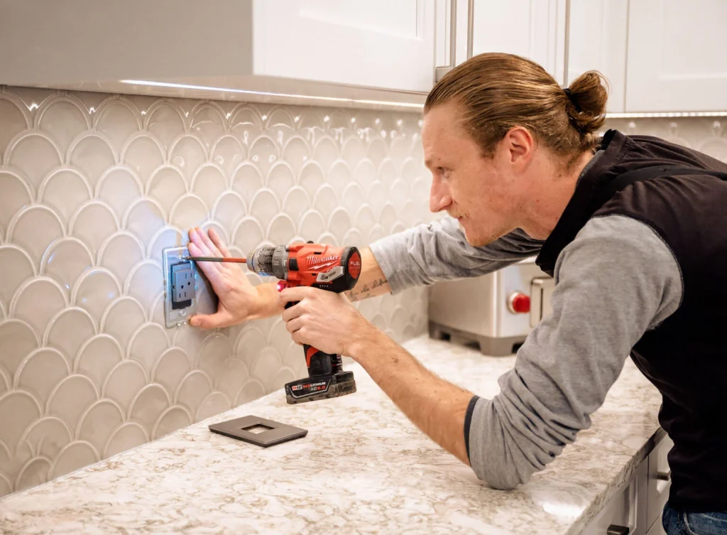 Licensed Wangler Electric electrician installing a modern kitchen outlet in Kelowna home