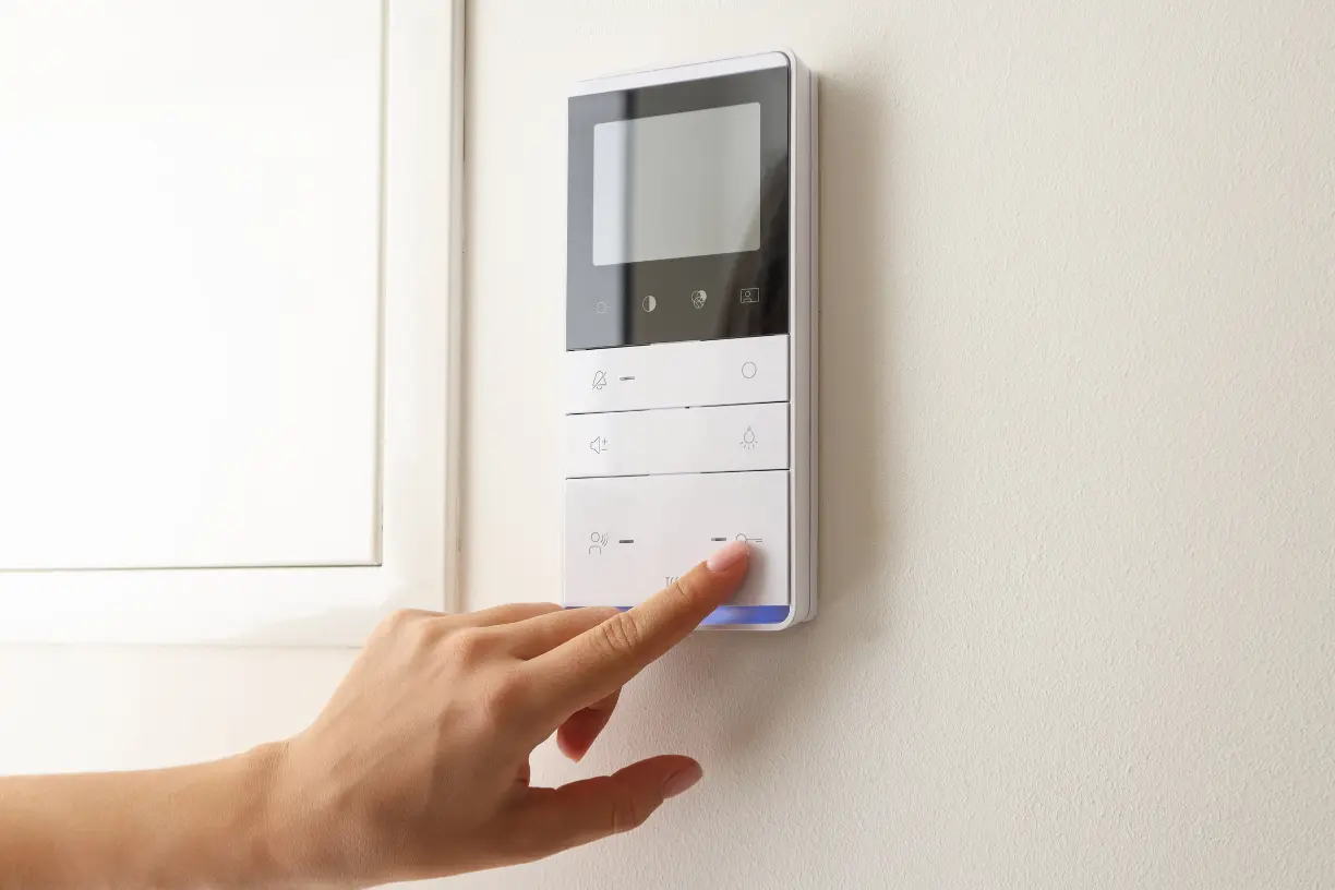 Home automation Penticton control panel being activated by a hand pressing a button